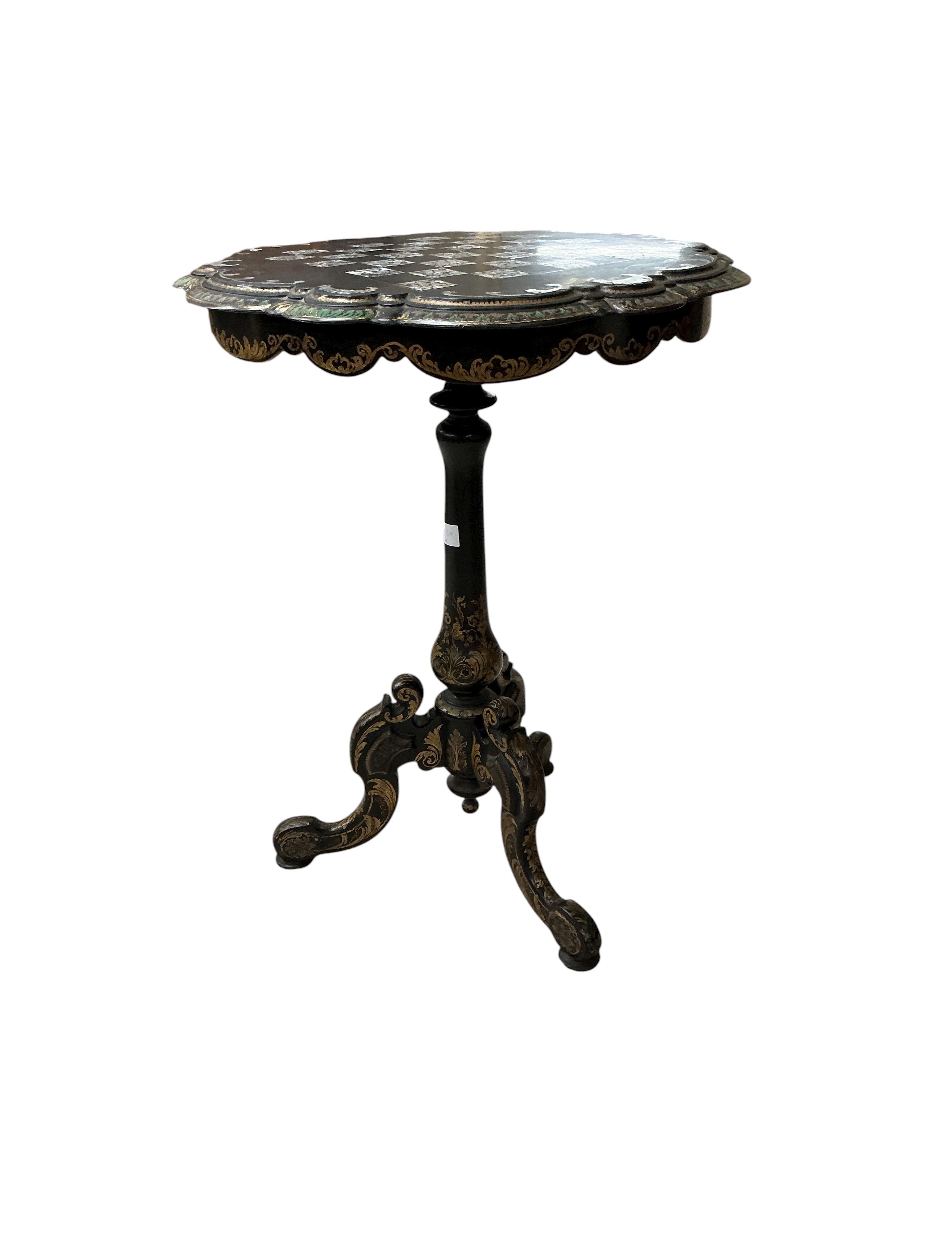 A Victorian mother of pearl inlaid papier mache circular tilt top tripod games table, diameter 56cm, height 74cm